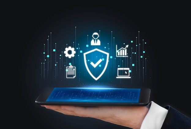 A digital shield icon with security and compliance symbols floating above a tablet, representing financial cybersecurity and adherence to regulatory standards.